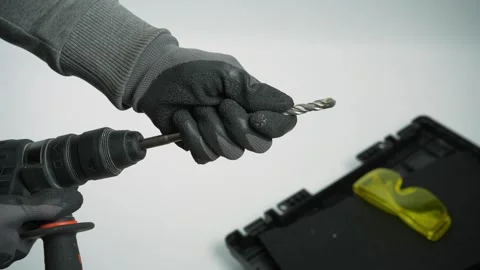 Electric drill in man's hand. Workman fitting drill bit onto drill. Close up Video stock 287244478