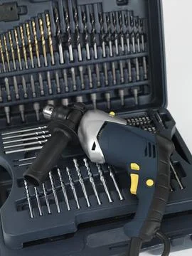 Electric drill with a set of drill and screwdriver bits Stock Photos