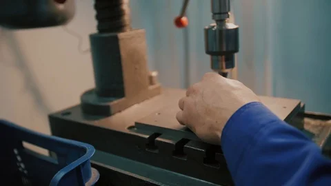 Electric drilling machine with manual pressure, a man holding a metal part Stock Footage 104877673