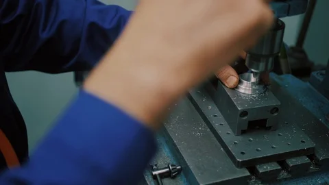 Electric drilling machine with manual pressure, a man holding a metal part Stock Footage 104877787