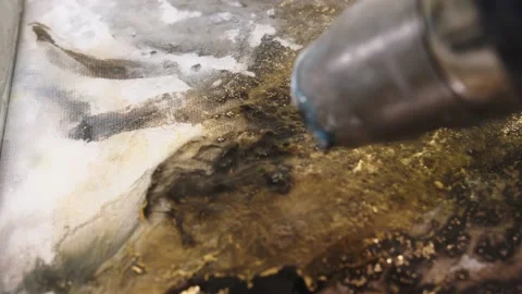 Electric dryer is blowing and spreading the fluid acrylic paints mixed with Stock Footage 201389020