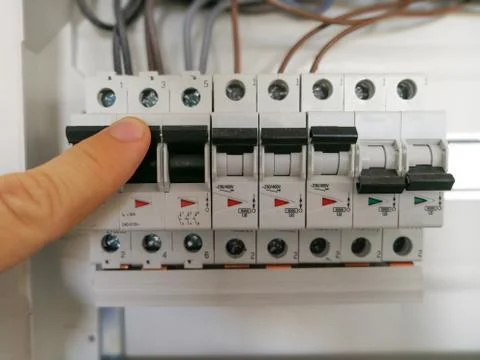 Electric engineer analyzes AC installation inside switch board cabinet Stock Photos
