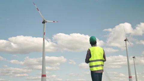 Electric engineer inspecting windmill turbine with tablet Stock Footage