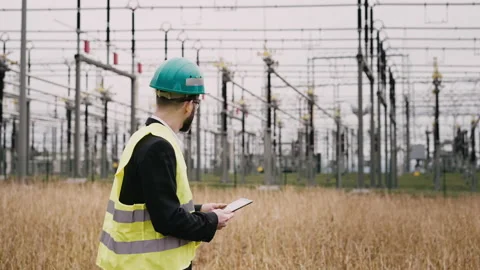Electric engineer wearing helmet suit and safety vest at bad weather checking Stock Footage 171547739