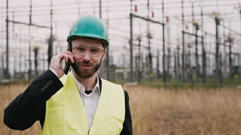 Electric engineer wearing helmet suit and safety vest at bad weather making Stock Footage 171547869