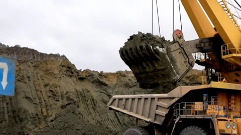 Electric excavator loads quarry dump trucks Video stock 77235722