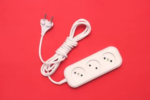 Electric extension socket set with cable on red background Stock Photos