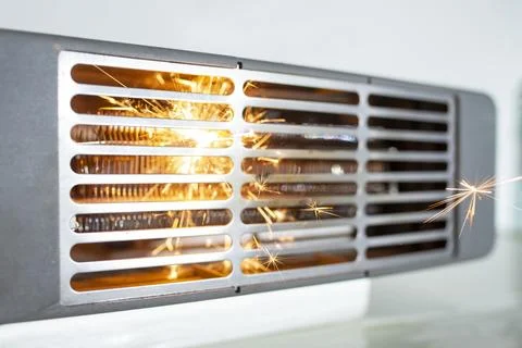 Electric fan heater exploding with sparks, domestic short circuit concept Foto stock