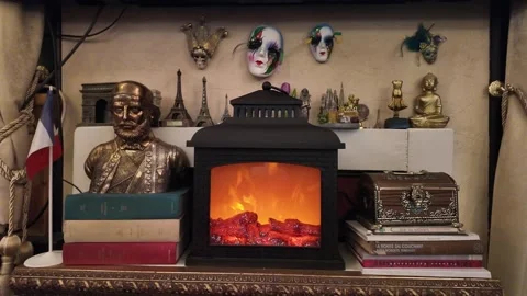 An electric fireplace surrounded by books. Stock Footage 317676192