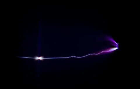 Electric flashover occurring between two electrodes due to corona effect. Stock Photos