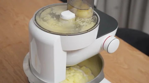 Electric food processor grating large amount of raw potatoes with motor sound 스톡 동영상 329168083