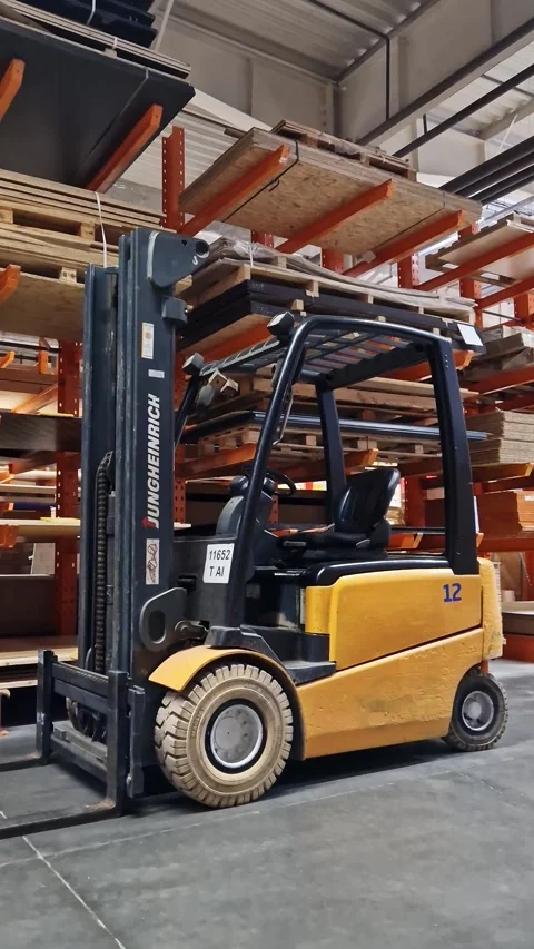 Electric forklift standing between racks with materials Stock-Footage 333703749