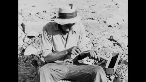 An electric fuse is inserted into a stick of dynamite that is placed in a hole Stock Footage 92626773