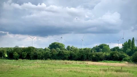 Electric generators against blue sky behind bushes and green meadow clean e.. Video stock 318786916