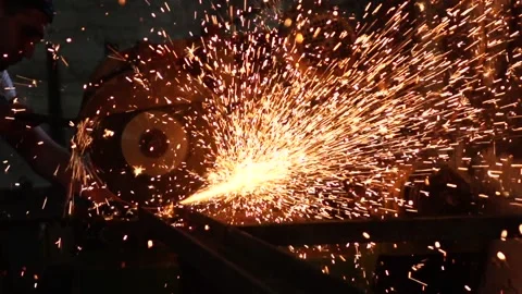 Electric grinder. A man working with electric grinder tool on steel structure Stock Footage 87733374