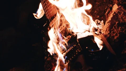 The electric guitar melts from the flame. Burning musical instrument Stock Footage 114519639