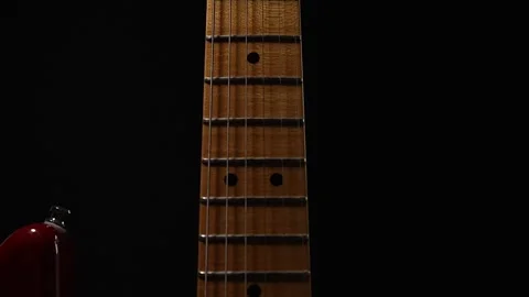 Electric guitar neck close up on a black background Video stock 280232201