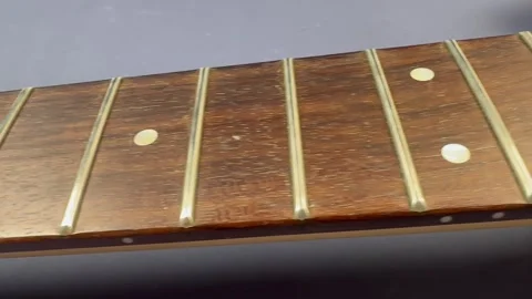 Electric guitar neck without strings close-up - tracking shot along fretboard Stock-Footage 317847949