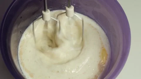 Electric hand mixer blades while kneading dough. Stock Footage 201145381