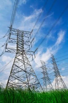 Electric high voltage power post with blue sky background Stock Photos