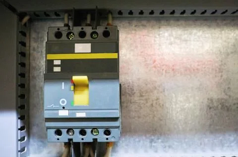 Electric input automatic with connected wires mounted on a metal surface. Stock Photos