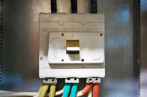 Electric input automatic with connected wires mounted on a metal surface. Stock Photos