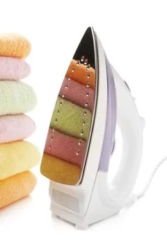 Electric iron and stack towels Stock Photos