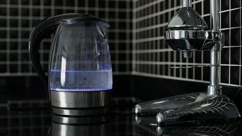 Electric kettle with blue highlight is starting to boil. Stock Footage 115859950