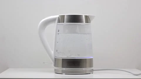 Electric kettle boiling with bubbles on a white background Stock Footage 136114995