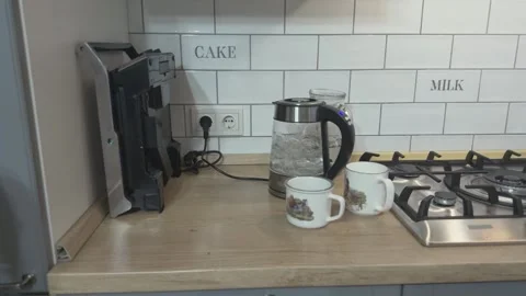 Electric Kettle Boiling With Two Cups Nearby Preparing Tea Or Coffee Video stock 336452245