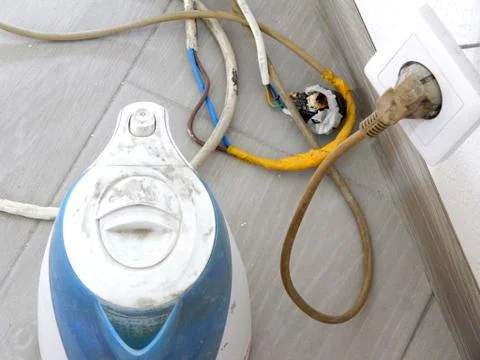 The electric kettle is connected through bare wires Stock Photos