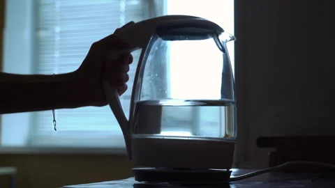 Electric kettle with neon lighting is placed on a stand against the background Stock-Footage 256203550