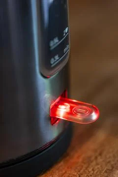 Electric kettle power switch with red light. Close-up detail of a kitchen a.. Stock Photos