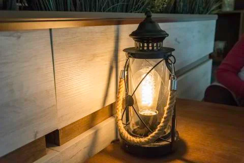 Electric lantern in a bar table with rope handle. shadow and light Stock Photos