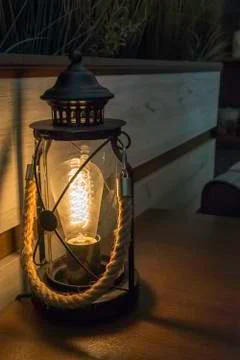 Electric lantern in a bar table with rope handle. shadow and light Stock Photos