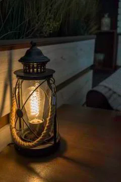Electric lantern in a bar table with rope handle. shadow and light Stock Photos