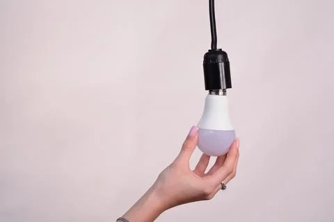 Electric LED light bulb. Changes on a white background. Stock Photos
