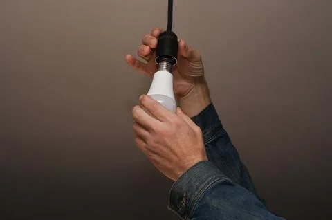 Electric LED Light bulb. Replacing the lamp with LED lamps. Stock Photos