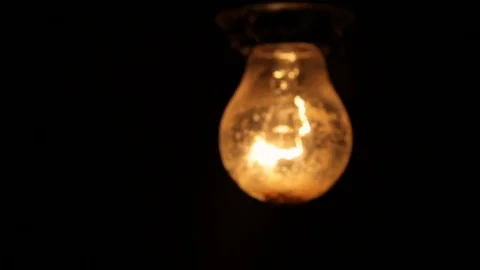 Electric light bulb on a black background Stock Footage 77711994