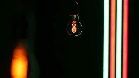 Electric light bulb on a black background. Stock Footage 154451100