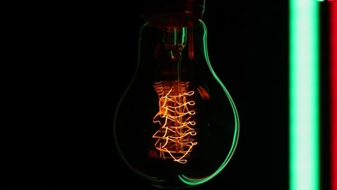 Electric light bulb on a black background. Stock Footage 154684098