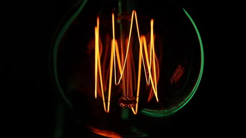 Electric light bulb on a black background. Stock Footage 154684771