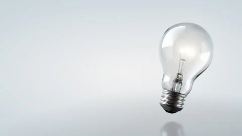 Electric Light Bulb Turns with Warm Light White Background Seamless. Shining 스톡 동영상 292888079