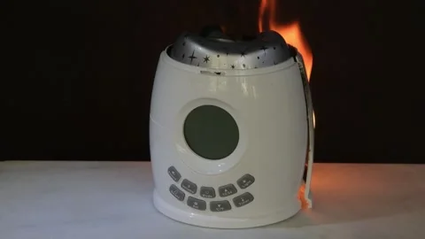 An electric light fitting catches fire due to overheating, posing a risk of fire Stock-Footage 332169638