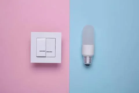 Electric light switch and led bulb on pink and blue background Stock Photos