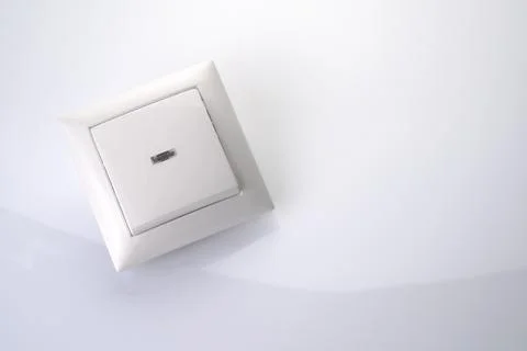 Electric light switch on a light background. Stock Photos