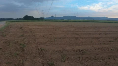 Electric line tower on farming fields in Slovenia. Wide shot, right pan Stock Footage 131301898