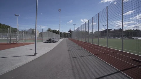 Electric Longboard summer ride on red sport stadium with playground 動画素材 90809996