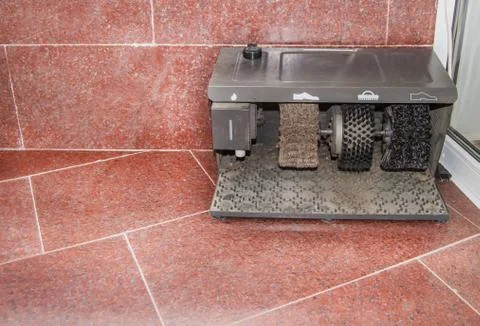 Electric machine for cleaning various types of shoes, LOCATED at the ENTRANCE Stock Photos