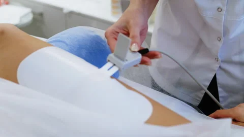 Electric Massage Setup. Cord Connection to Device on Clients Leg Stock Footage 306276508